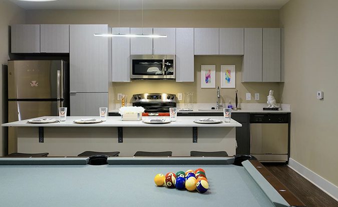 Apartment kitchen with pool table