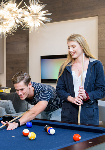 young adults playing a game of pool